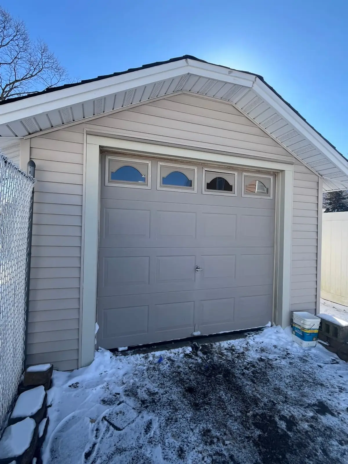 Selling a house for a job relocation in Lindenhurst: detached garage with a carriage-style door